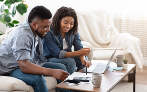 Couple on couch doing finances